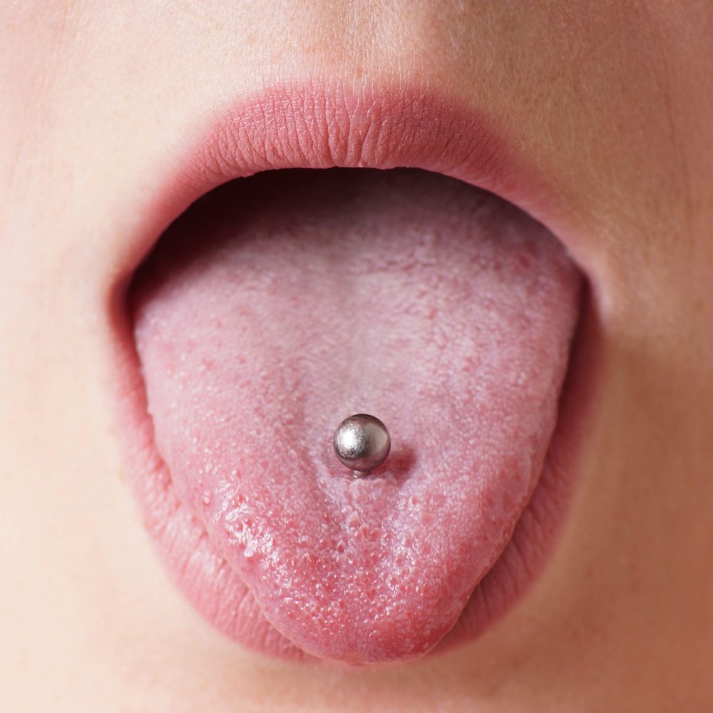 close-up of a female mouth with tongue piercing
